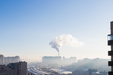 Urban landscape smoked polluted atmosphere from emissions of plants and factories, view of pipes with smoke and residential apartment buildings.Ecology conceptの写真素材