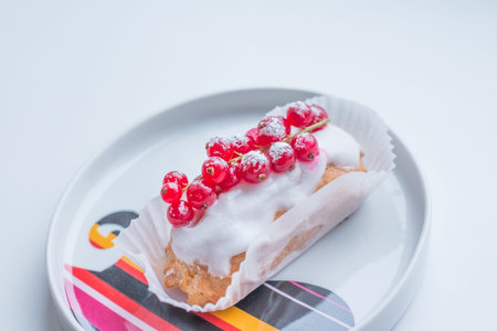 Eclair cake. Sweet delicious eclairs isolated on white. Traditional french cakes with a cream and...
