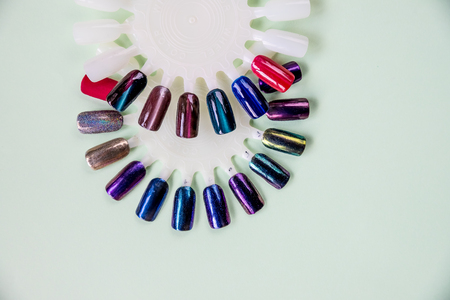 Nail varnishes.palette with swatches of nail Polish. a collection of samples of varnish for manicure. well-groomed hands, healthy nails.Selective focus. Copy space.Finger nail art design samples.の写真素材