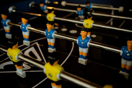Table football game with yellow and blue players.Selective focus.