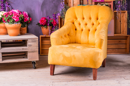 Still Life of Vintage Chair in Living Room.Terrace lounge with comfortable yellow arm chair,divans in a luxury house. garden furniture at the patio. Architecture modern design,veranda of modern house.の写真素材