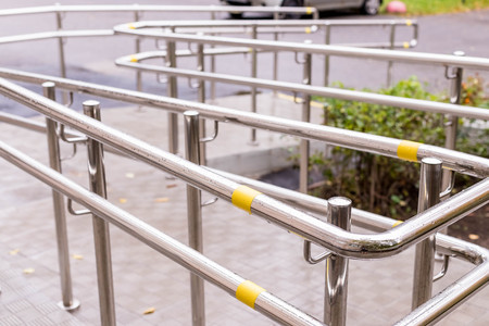 wheelchair entry, outdoor object, nobody.Way of wheelchair, concrete ramp way with stainless steel handrail with disabled sign on the floor for support wheelchair of disabled people.Selective focusの写真素材