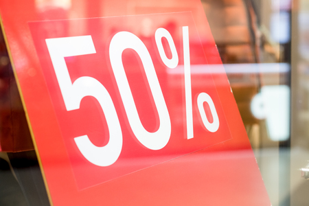 store discount sign. window display with text SALE in a shop.Shopping and saving the family budget concept.smart shopping.winter and off-season discounts.Shopping mallの写真素材