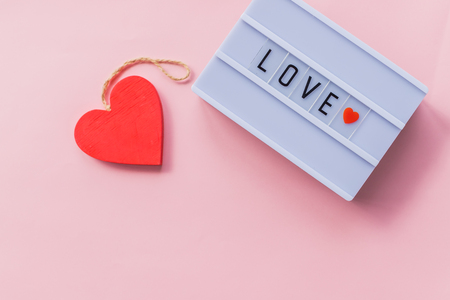 Love is a word is written spelling font. The word love red. Love inscription on the background a beautiful backdrop. Love the key to the heart. Love Story. Text about love. Space for text.の写真素材