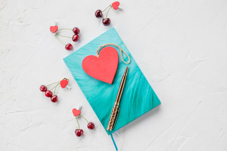azure notebook, clips, pen and red hearts on white background. Flat lay top view Place for text .Mock up Copy space. Goal, mean, resolution, congratulation.Valentines day background.Mothers day.planning and dream conceptの写真素材
