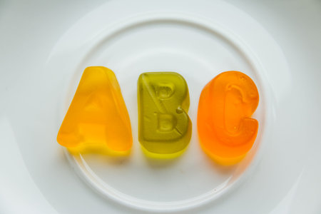 Jelly bean sweets and ABC letters. Education and alphabet concept.food sweet letters. Sweet alphabet. ABC text, Message lined with edible letters, Letters ABC for children alphabet learning . healthy eatingの写真素材