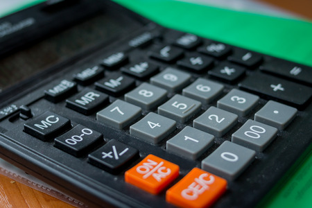 calculator isolated on white background, device for calculating the numbers.Top view of calculator and writing numbers down. Concept of accounting work.Office tableの写真素材
