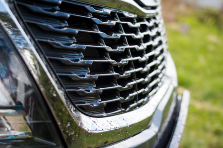 Grid of car. Radiator grille. Metal close-up texture background. Chrome grill of big powerful engine macro. Auto detail.Selective focusの写真素材