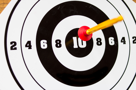 Playing toy darts. Kids game.The concept of setting targets and trying to reach them. Closeup.success ,winner and loser concept, selective focusの写真素材