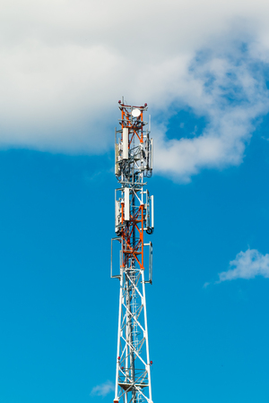 3G, 4G and 5G cellular. Base Station or Base Transceiver Station. Telecommunication tower. Wireless Communication Antenna Transmitter. Telecommunication tower with antennas against blue sky with clouds.の写真素材