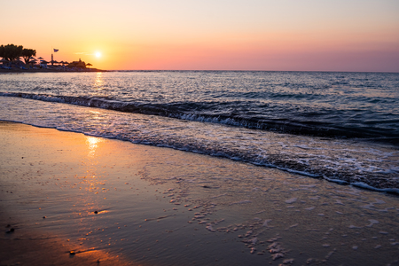 Beautiful cloudscape over the sea, sunset shot.majestic sunset over sea shore. romantic evening on the beach.freedom and inspiration over the ocean.waves on beach at sunset time , sunlight reflect on water surface.の写真素材