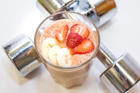 Fresh Color Juices Smoothie,Tropical Fruits Mango Melon Kiwi Strawberry Banana Peaches Grapes in Glass on White Background. Summer Concept.Fitness drink and food. Diet cocktail.の写真素材