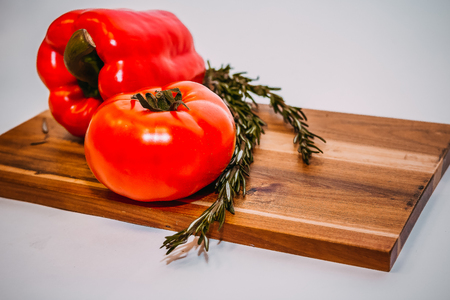 bell peppers, rosemary, tomatoes, ingredients for cooking on wooden rustic background, place for text.raw organic vegetables, fresh ingredients for healthily cooking.Vegetarian, healthy foodの写真素材