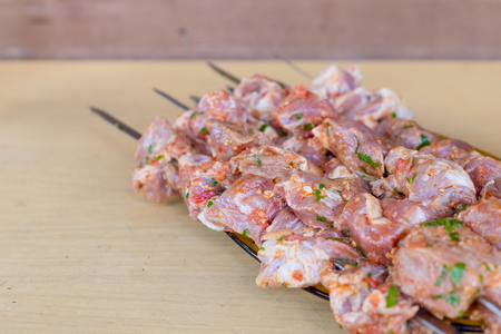 Fresh raw meat skewers kebabs on plate.Meat prepared for marinating on cutting board.Kebab, raw meat and vegetables on skewers, ready for grilling.beef meat fillet shish kebab on skewers.の写真素材