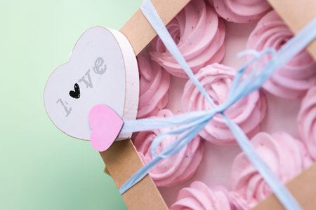 Homemade pink zephyr or marshmallow in pink box, close up. Tasty food concept - Marshmallow, Meringue, Zephyr. Valentine's or Mother's Day concept.の写真素材