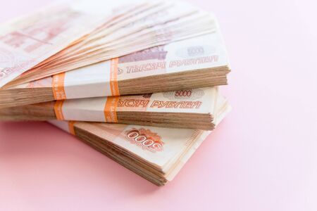 Russian rubles isolated on pink, packed stack of banknotes.Russian money 5000 rubles banknote closeup macro, win concept of russia rouble money.economy, crisis, currency exchangeの写真素材