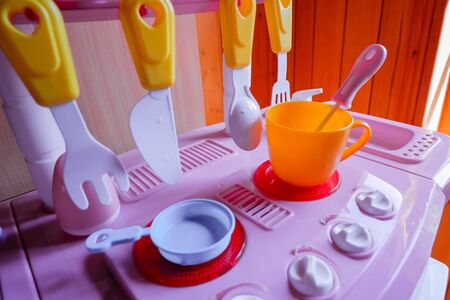 Set of Kitchen utensils. Childrens toys. Childrens kitchen game.Girls plastic kitchen for playing with various colors in the room.Kidergarden and girls games. Role play, cookの写真素材
