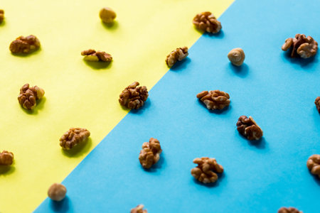 Isolated nuts pattern backdrop. Walnut, cashew, almond and hazelnut on colorful background. Top...