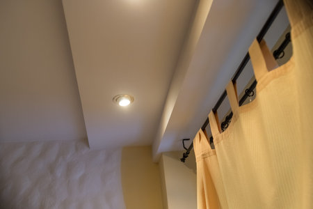 Modern curtain in hotel on warm feeling. Yellow curtains, Windows, multi-level ceiling.New real...