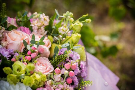 Flower background with roses, ranunculus,Pumpkin Hypericum, chrysanthemum.Spring, summer floral arrangement for birthday ,lover,friend.Elegant gift of flowers for wedding or other celebration.の写真素材