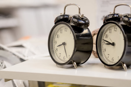 minimal style with Old Alarm Clock, in black and white, showing almost 9 oclock.waiting for an...