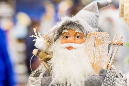 Santa Claus with a bag full of presents.Santa Claus doll isolated on blurred background.Christmas Xmas holiday concept.Santa Claus toy brings gifts,New Year s market banner, poster.の写真素材