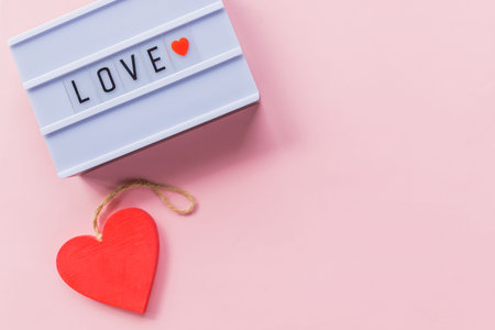 Photo of a light box with text, LOVE, over isolated background