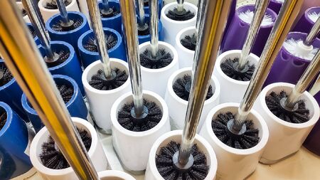 Toilet brush, toilet brushes for sale in the store, close up.Colorful Plastic toilet brush background. New brush for cleaning toilet. Clean up accessory with handle.cleaning supplies.の写真素材