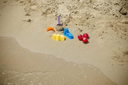 Christmas toys, decorations on the sand beach against ocean.Christmas decorations and childrens toys...