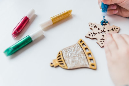 Workshop, girl mades a wooden christmas ornaments. Material for creativity. Step-by-step master...