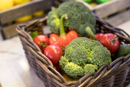 Fresh vegetables in basket on the table. red tomatoes, broccoli, potato, peppers,red paprika. Bio Healthy food, herbs and spices. Organic vegetables. Selective focus.の写真素材