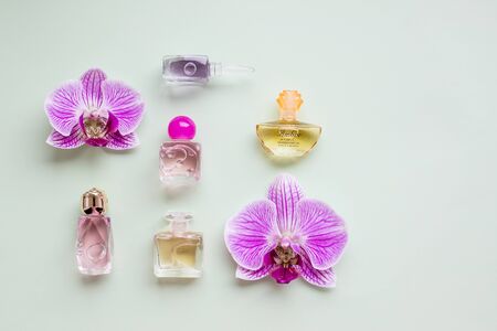 bottle of womens perfume and a delicate orchid flowerの写真素材