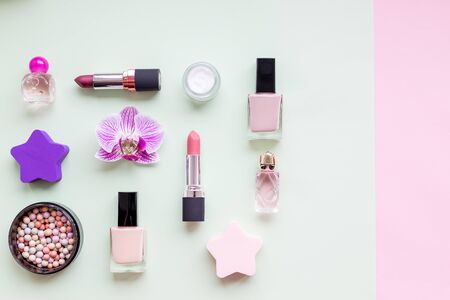 Creative flat lay of fashion bright nail polishes and decorative cosmetic on a colorful background. Minimal style. Copy space. Beauty blogger concept. Various womens makeup cosmetics.の写真素材