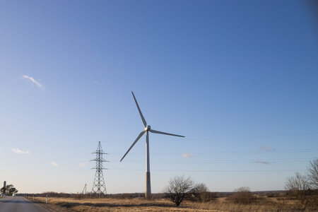 Wind Turbines in wind farm against cloudy sky.Eletric Power Generator Wind Turbine over...