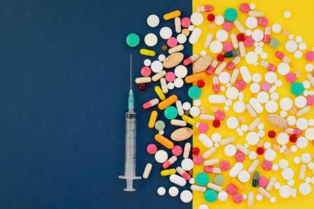 anti-virus medical supplies. deadly coronavirus epidemic. mask, syringe with vaccine and antibiotic pills. concept: Respiratory disease.Multicolored pills,Medical concept of Virus Pandemic Protection,の写真素材