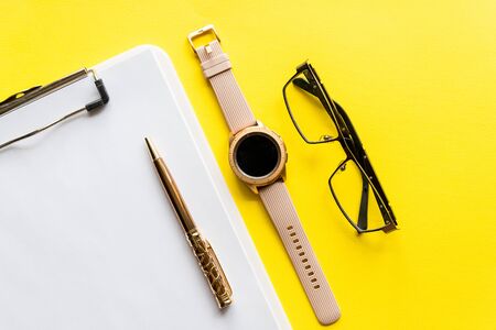 Home office workspace mockup with clipboard, glasses and accessories. Flat lay, top view. Template for blog, bloger, businessの写真素材