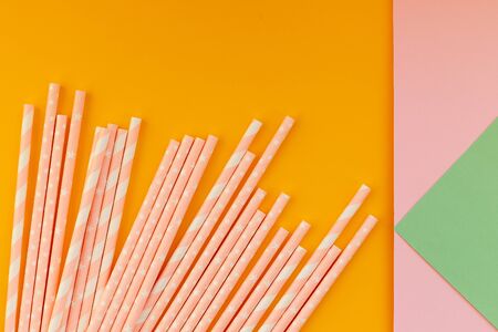 paper drinking straws on yellow,colorful background. Zero waste nature friendly biodegradable materials. Birthday party holiday celebration background.Copy spaceの写真素材