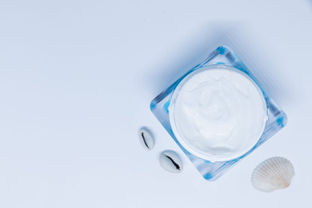 Spa product, organic skin care and natural emulsion concept .Sensitive skincare moisturizer beauty face cream, sea shells on pastel background. luxury anti-age cosmetics.Copy space.の写真素材