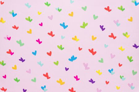 colorful paper heart shape on pink background. hearts pattern design useful for textures and background.Valentines day concept. Rainbow hearts pride theme seamless pattern.gay and LGBT.Free loveの写真素材