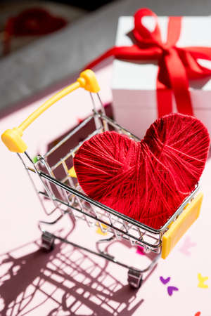 Love heart gift box in a shopping cart trolley.Shopping stores to buy Love Heart concept. Valentine Day. Find couple lover.heart in shopping cartの写真素材