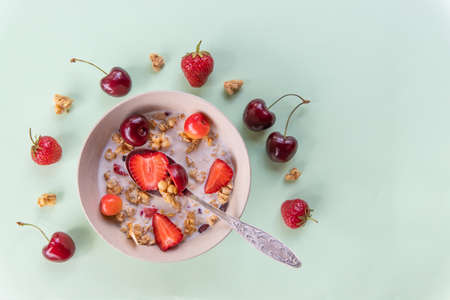 bowl of muesli and yogurt with fresh berriesの写真素材