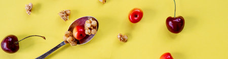 Healthy breakfast meals on yellow table, copy space. Cornflakes, muesli, berries and spoon, top...