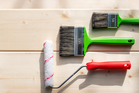 Set of tools for painting on wooden backgrond.painting wall by the roller brush for protection and...