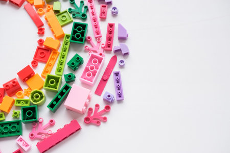 Toys background. Colorful cubes and plastic construction blocks frame on white background.Frame from...