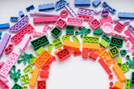Toys background. Colorful cubes and plastic construction blocks frame on white background.Frame from different shapes plastic blocks.Creative, logical thinking concept. Flat lay. Copy space.の写真素材