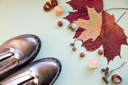Autumn look with shiny boots on pastel background. concept Autumn, fashion composition. Casual boots...