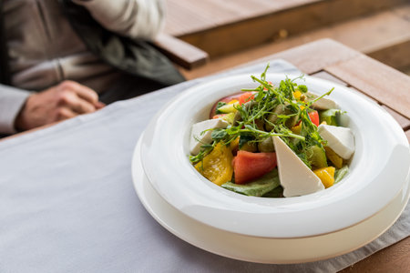 Greek salad with fresh vegetables, feta cheese and black olives.Mediterranean style salad with...