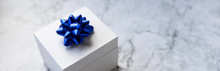 white gift box with red bow on the marble background. Holiday banner for website.Greeting web banner with blue gift box. Pink bows.の写真素材