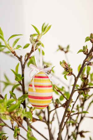 festive colorful Easter eggs.A bunch of purple, white and dotted Easter eggs hanging from tree...