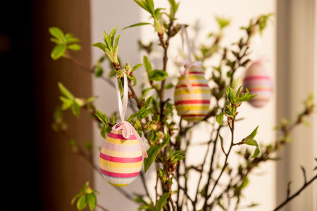 festive colorful Easter eggs.A bunch of purple, white and dotted Easter eggs hanging from tree...